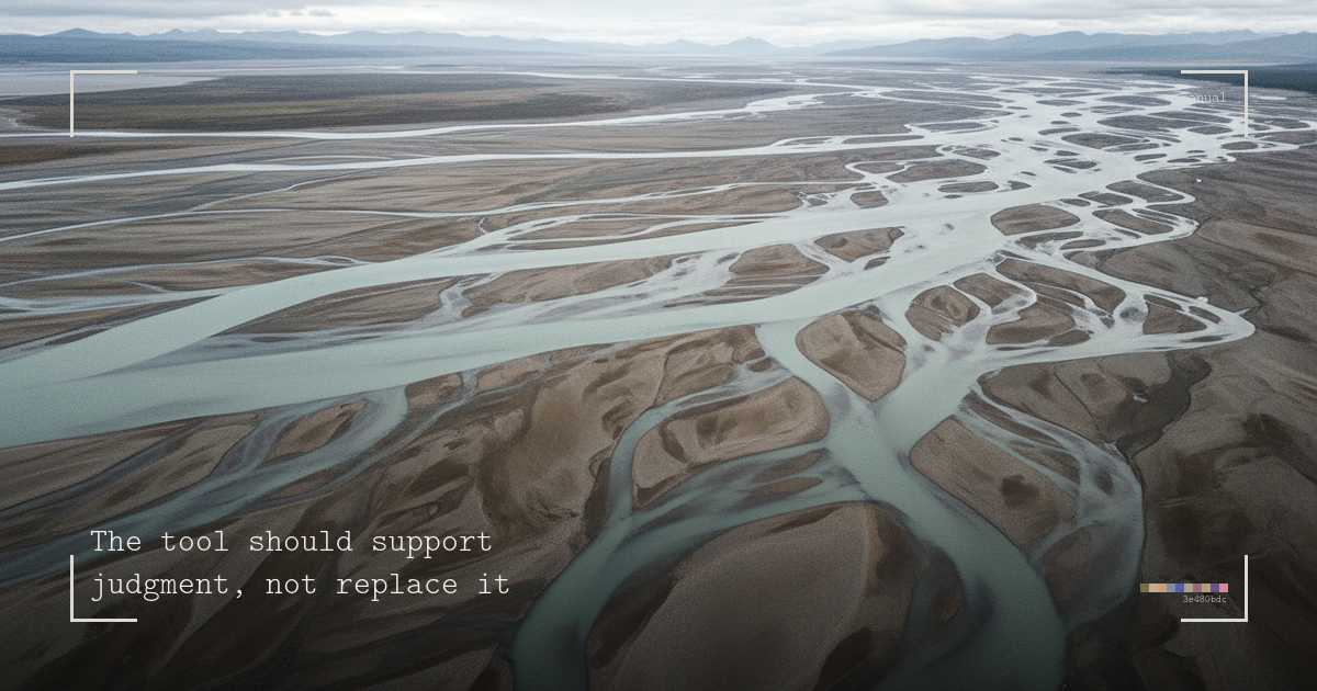 Aerial view of a wide braided river delta, dozens of shallow channels fanning across a flat gravel plain